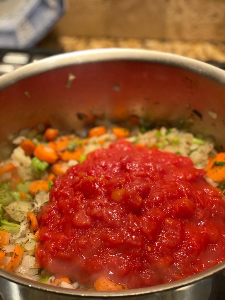 a pot filled with vegetables and tomato sauce