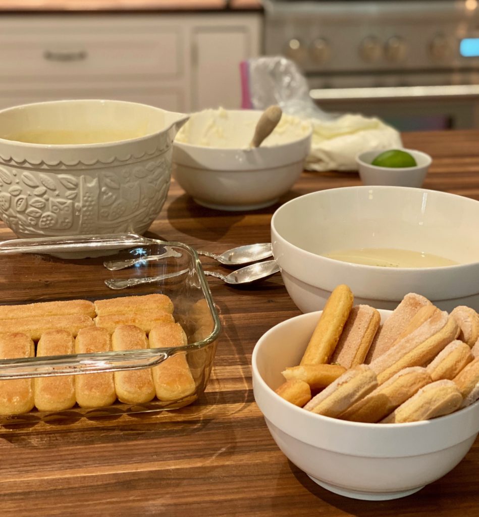 A table with ingredients of a tiramisu recipe spread out 