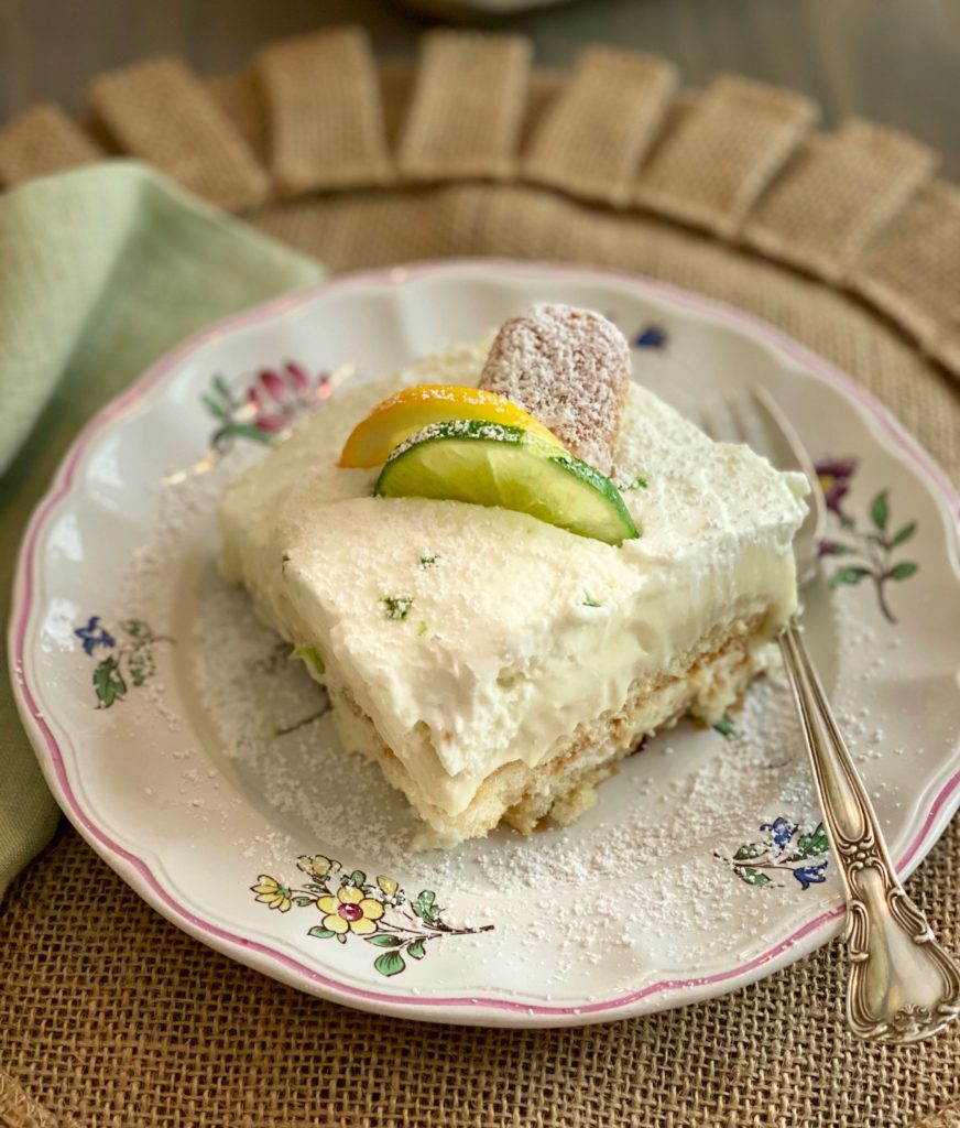 A plate with a slice of tiramisu and a silver fork