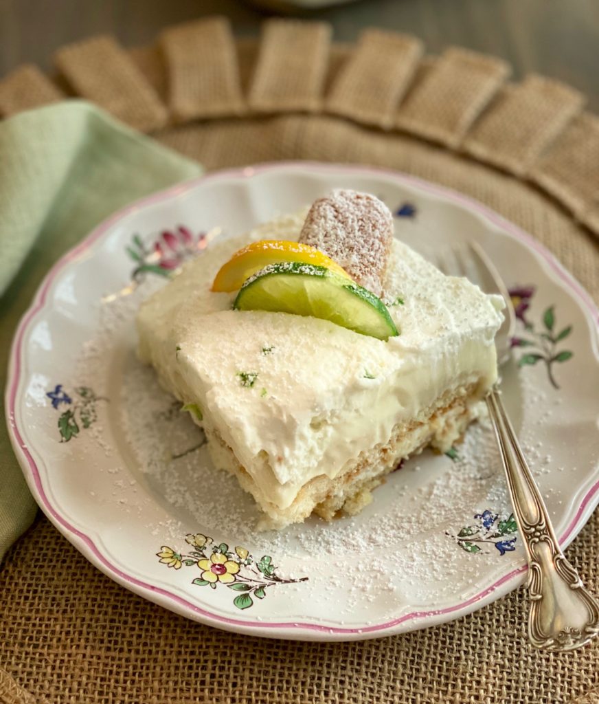 A plate with a slice of tiramisu and a silver fork 