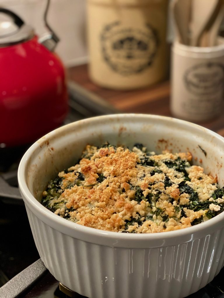 a casserole filled with a spinach gratin