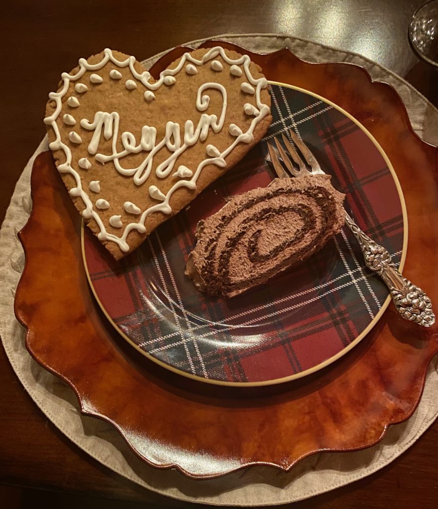 a plaid plate with a slice of chocolate cake and a gingerbread cookie 