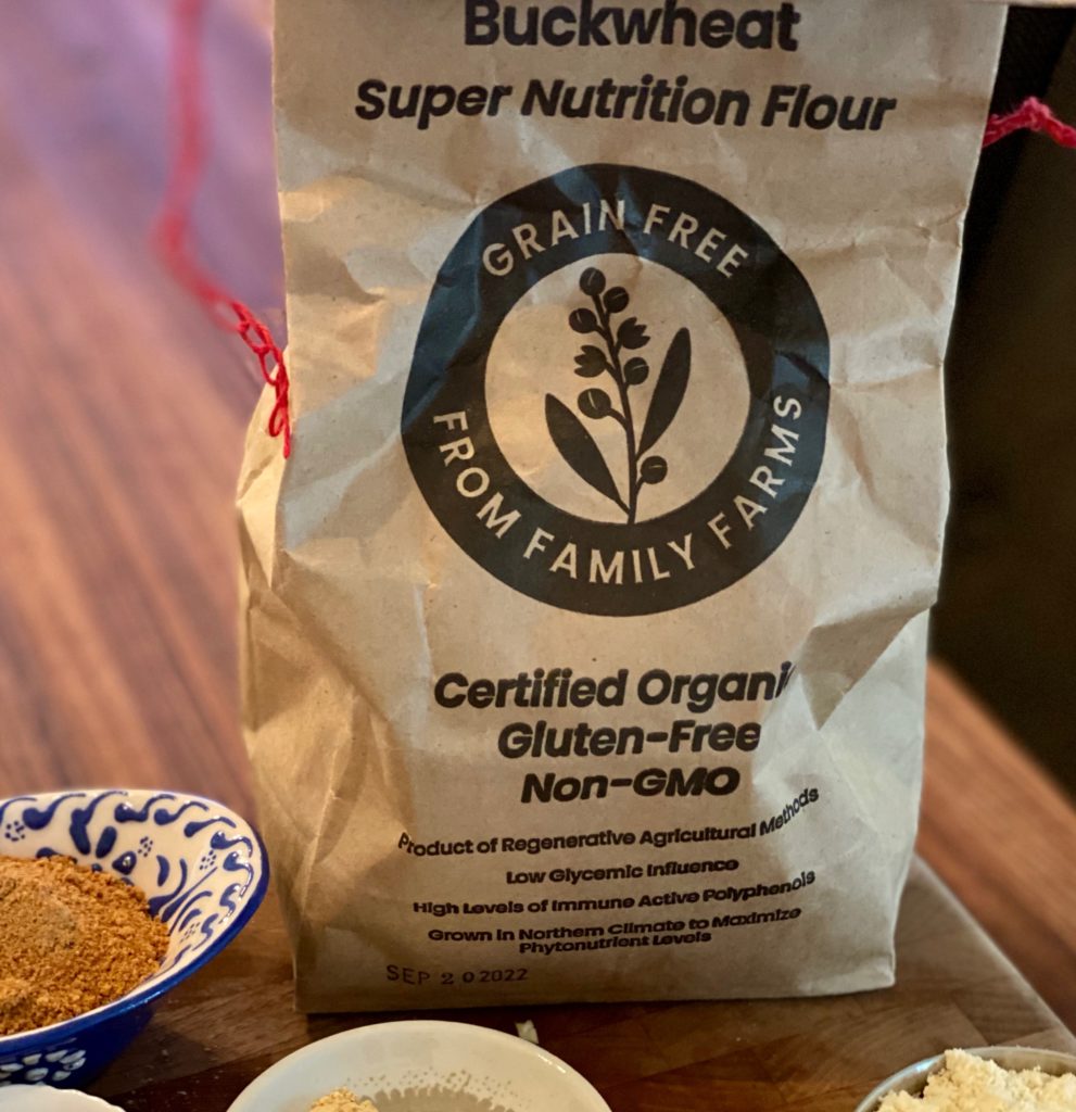 A brown bag of buckwheat flour labeled "grain free from family farms"