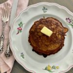 buckwheat pancakes and butter on a floral plate