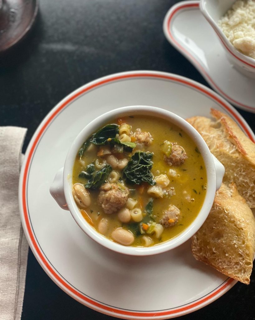 A steaming bowl of Italian wedding soup