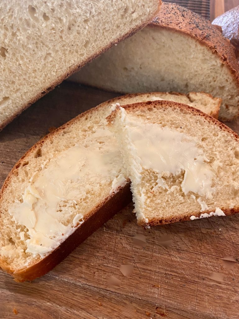 two slices of bread with butter spread on them 
