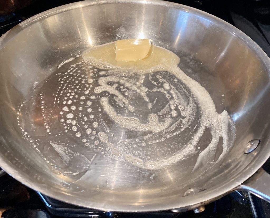 a 12" pan with a pat of melting butter
