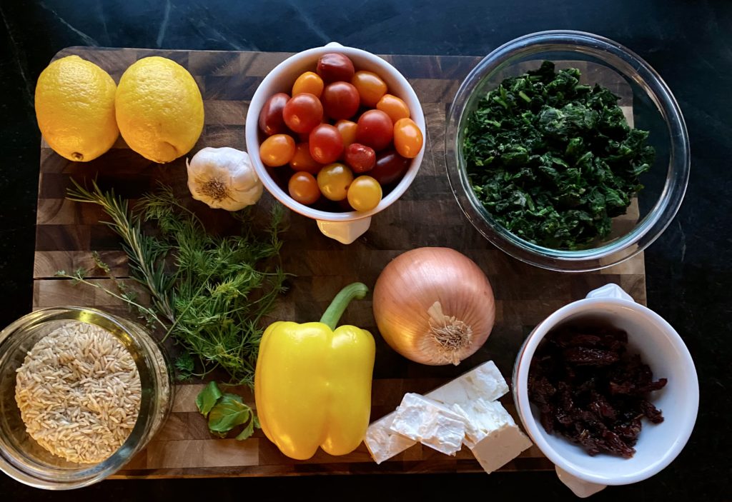 a board filled with vegetables and rice 