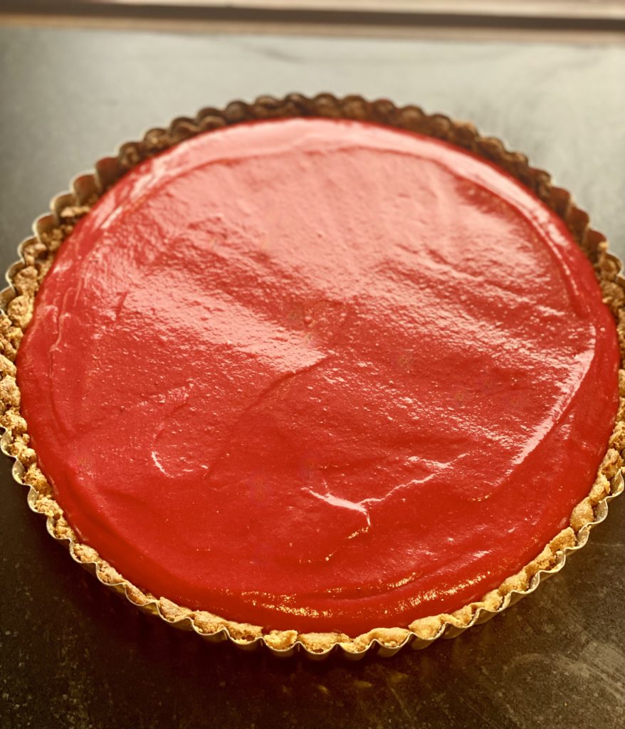 a bright red curd in a baked tart crust