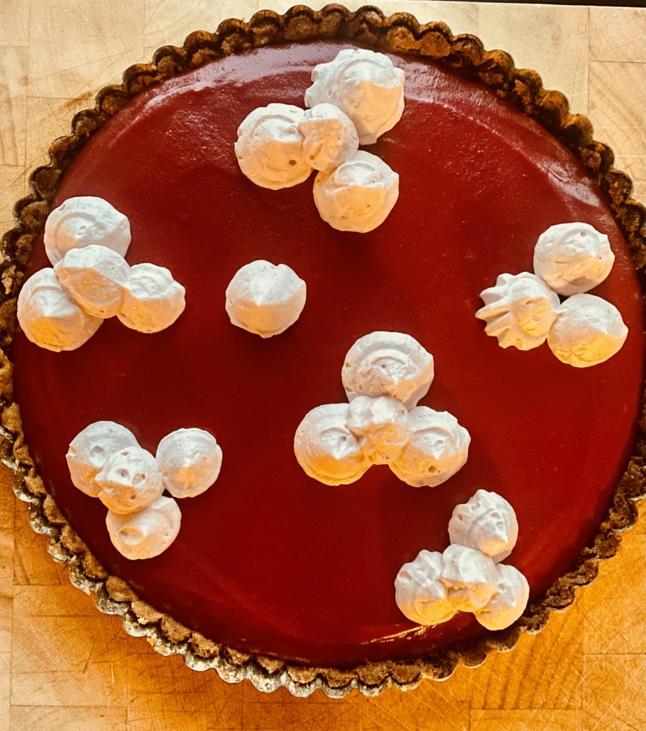 a tart with dollops of whipped cream 
