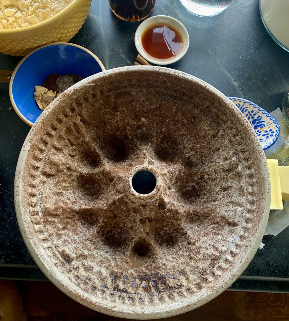 the inside of a cake pan dusted with cocoa powder