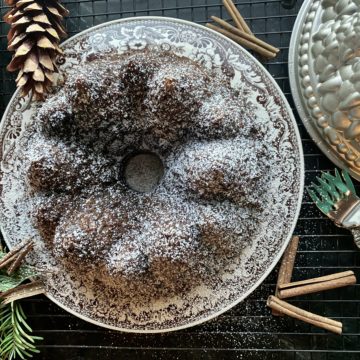 a bundt cake on a plate dusted with powdered sugar