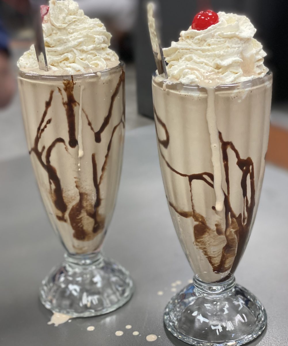 two chocolate mil shakes in tall glasses