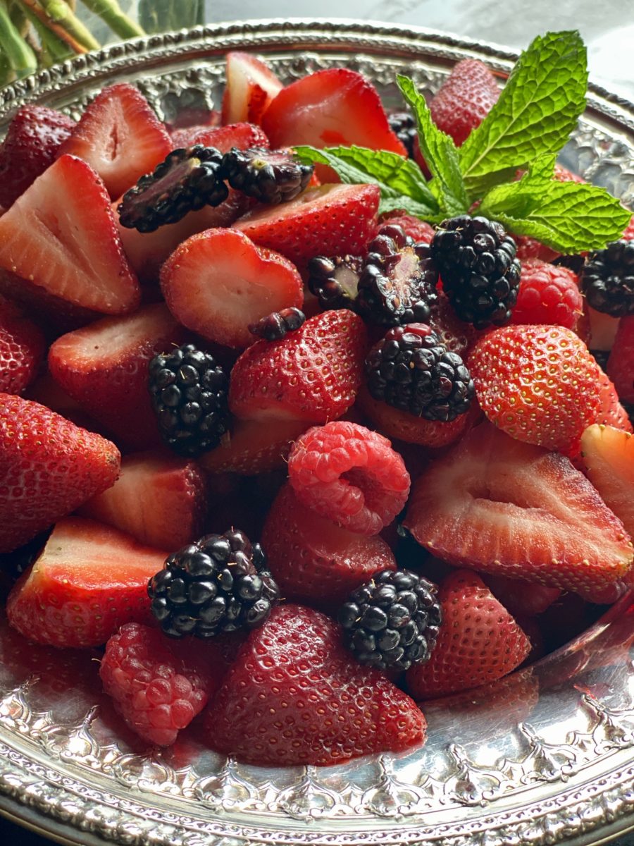 a silver bowl filled with fresh berries