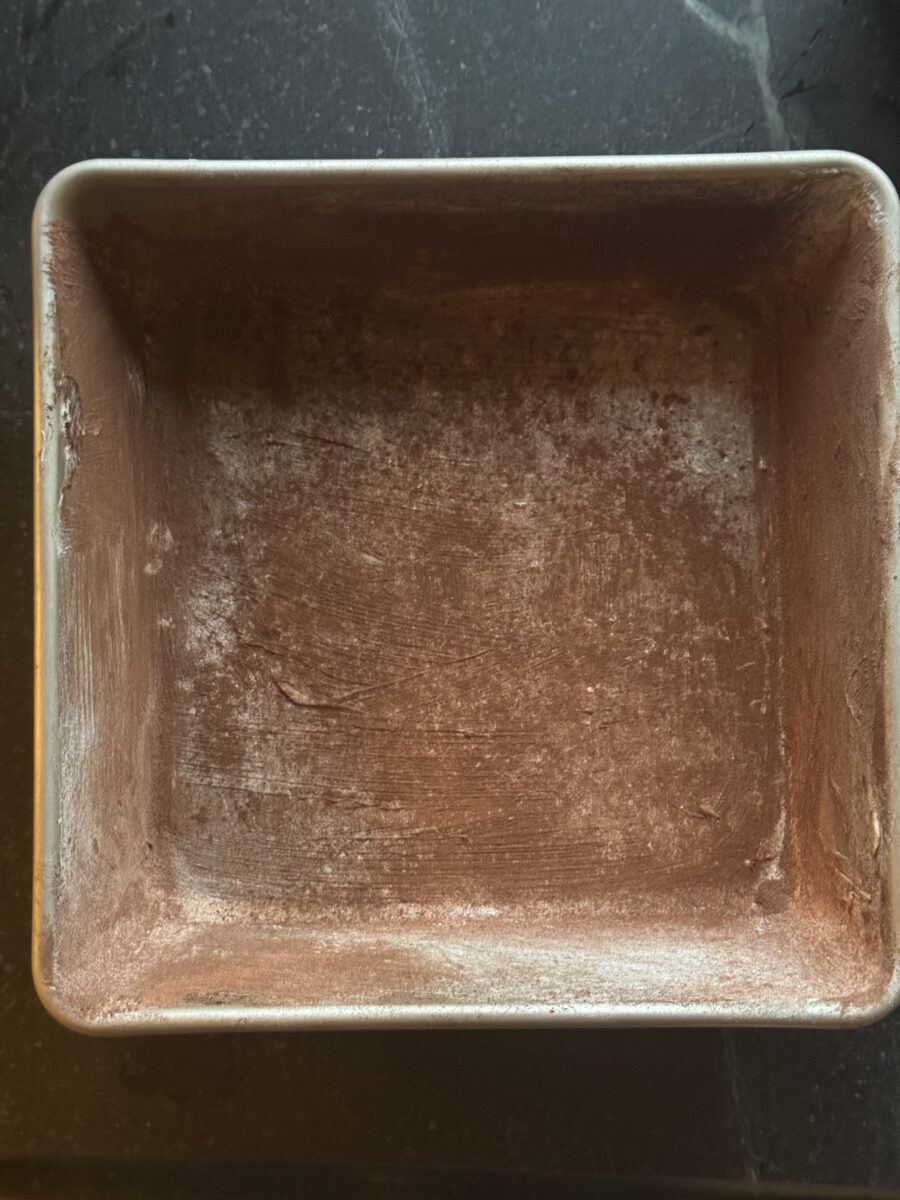a square baking dish dusted with cocoa powder
