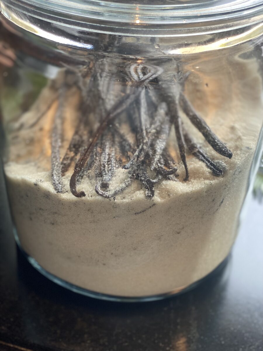 a glass jar filled with sugar and vanilla beans