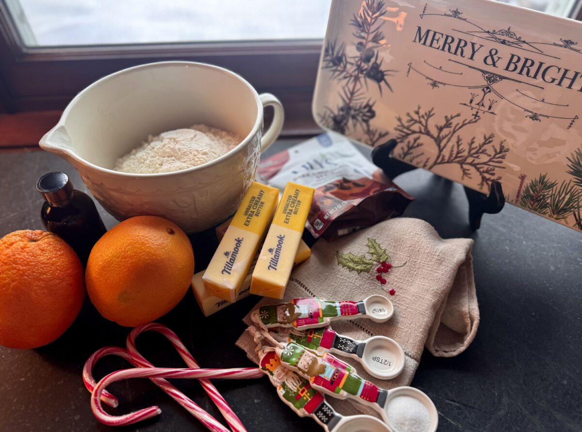 ingredients for orange shortbread cookies on a dark soapstone counter 