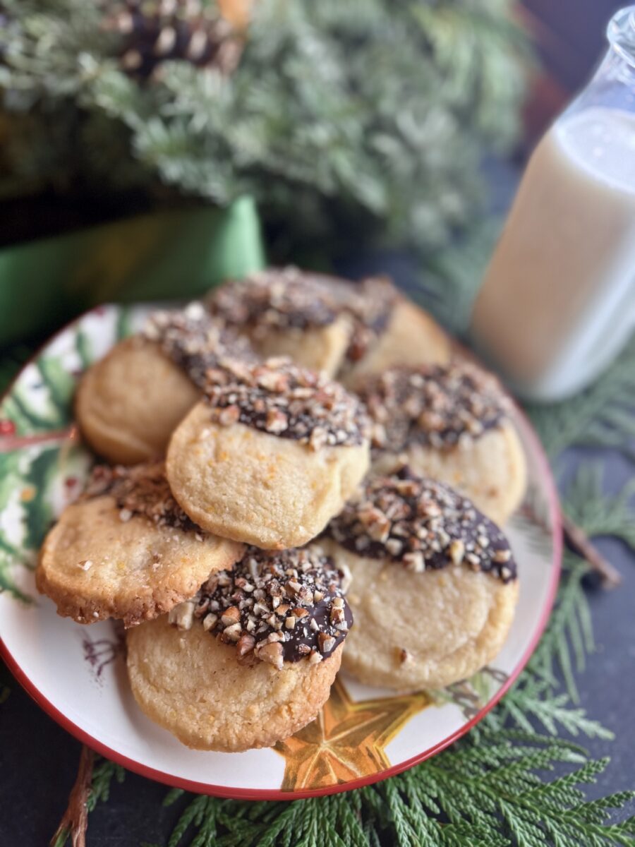 orange shortbread cookies dipped in dark chocolate and sprinkled with finely chopped pecans
