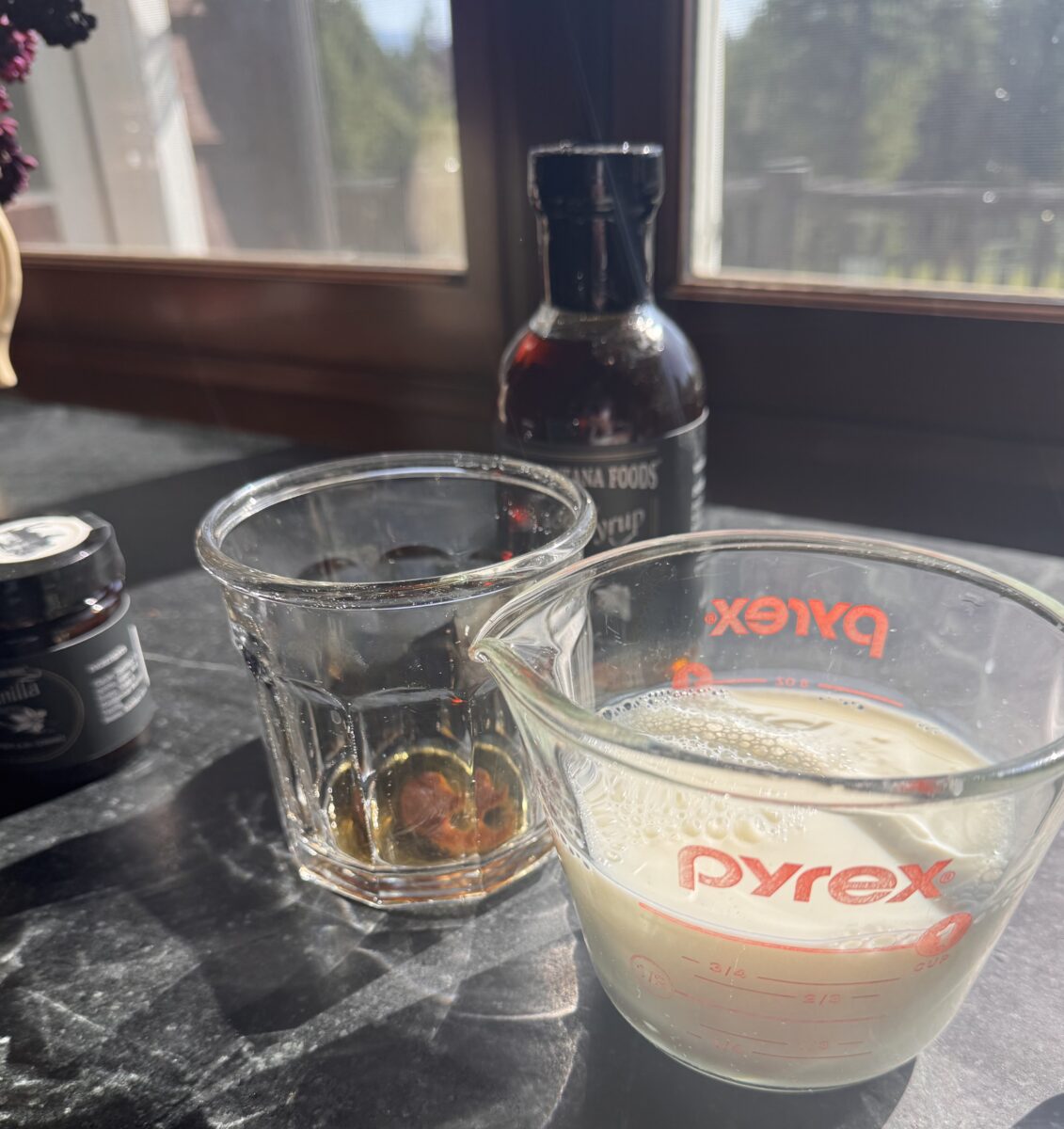 a glass pyrex measuring cup filled with 8oz of milk